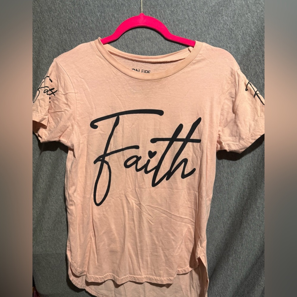 Light Peach color says Faith on the front and a saying on the back! 💕